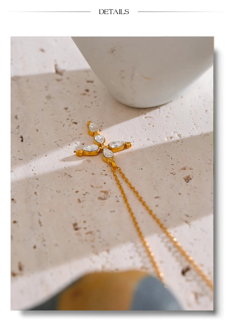 Cubic zirconia cross necklace in gold-plated stainless steel with cubic zirconia.