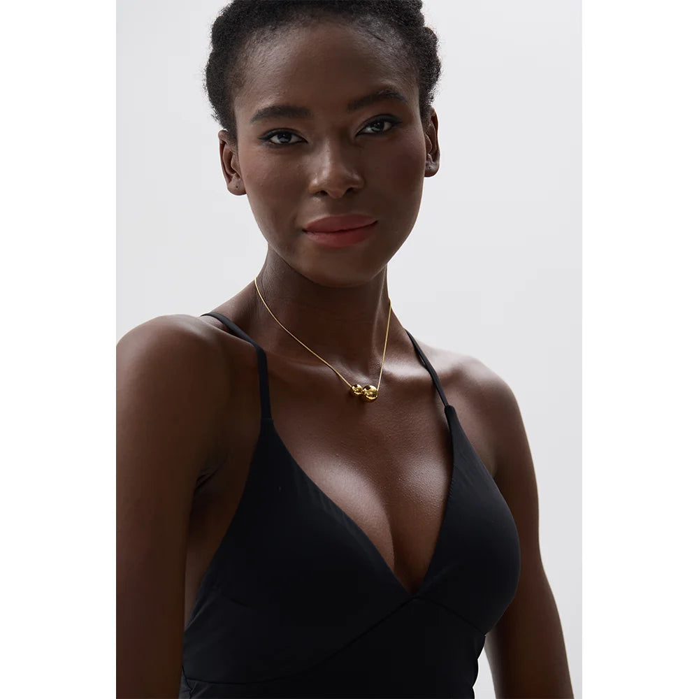 Beaded geometric necklace in gold-plated stainless steel.