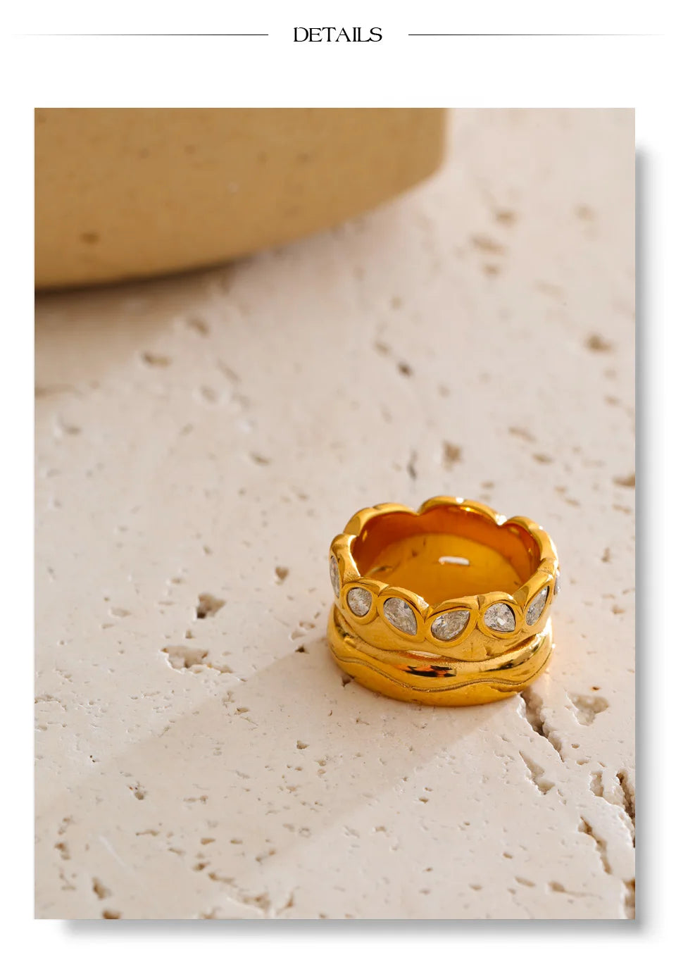 Cubic zirconia geometric ring in 18K gold-plated stainless steel with cubic zirconia.