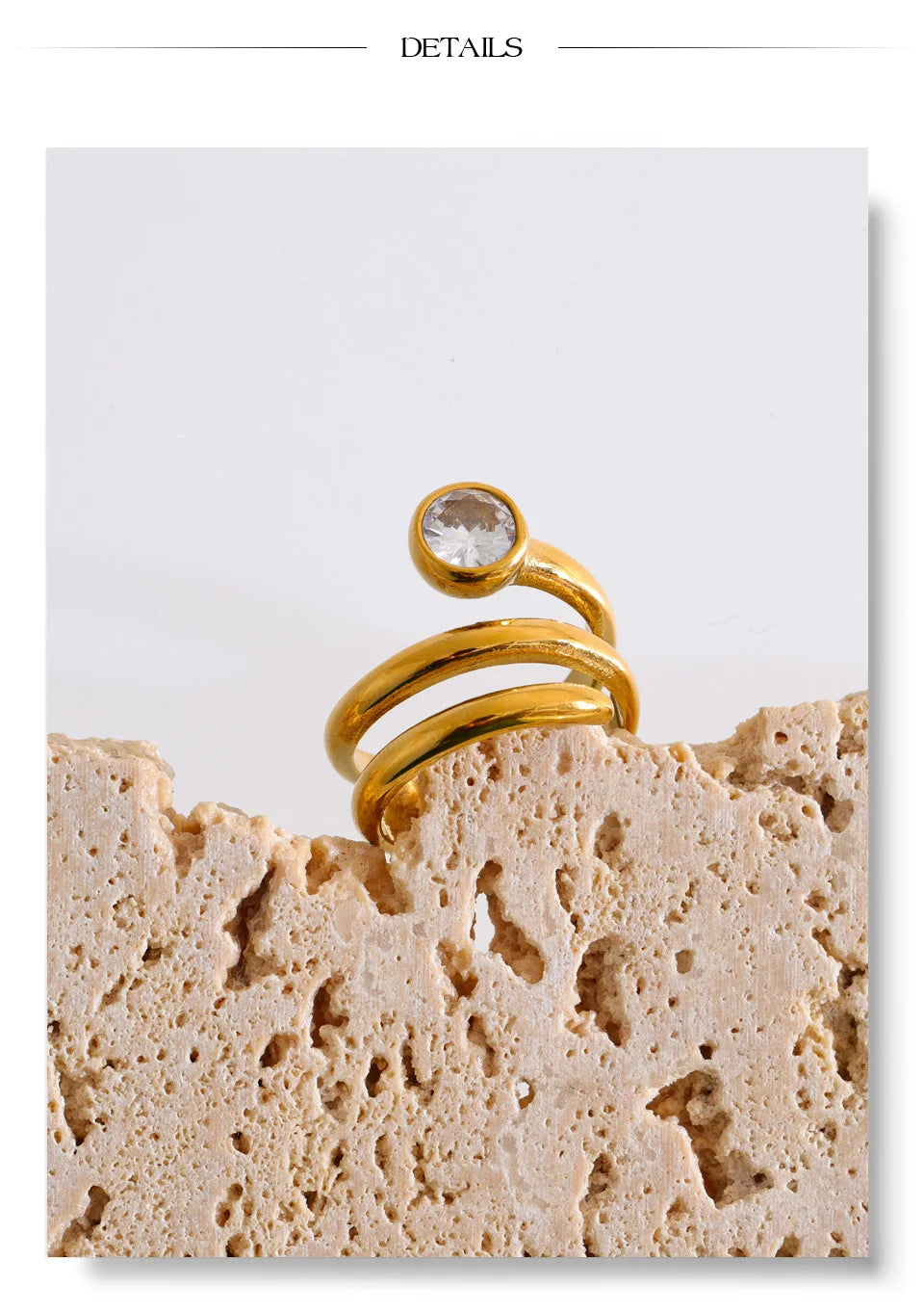 Cubic zirconia geometric layered ring in 18K gold-plated stainless steel with cubic zirconia.