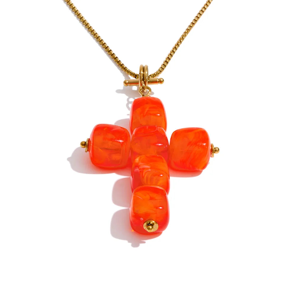 Resin acrylic cross necklace in gold-plated stainless steel with resin and acrylic.
