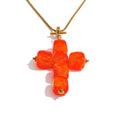 Resin acrylic cross necklace in gold-plated stainless steel with resin and acrylic.