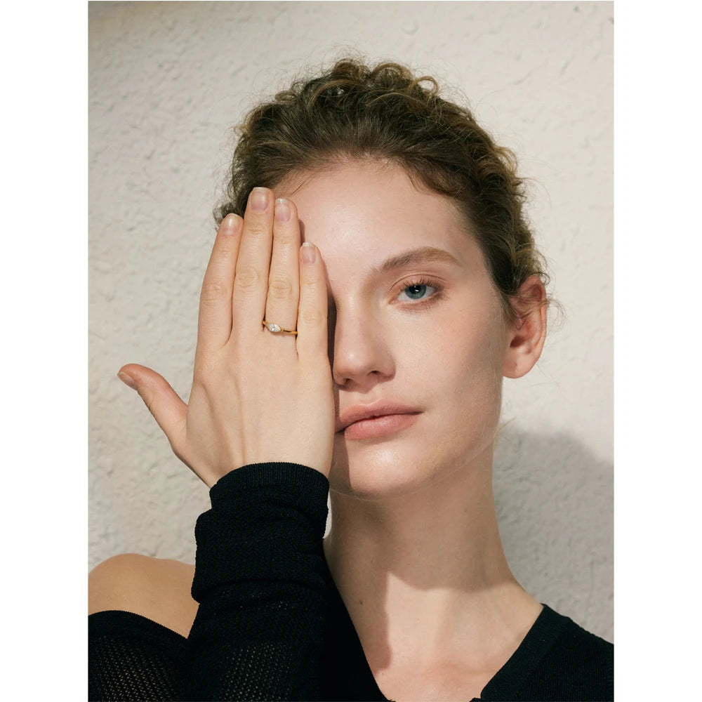 Cubic zirconia geometric ring in 18K gold-plated stainless steel with cubic zirconia.