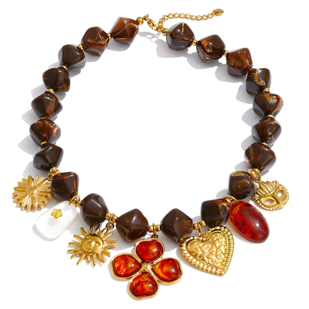 Gold-plated stainless steel necklace with resin and acrylic beads, featuring a combination of brown, red, and white stones.