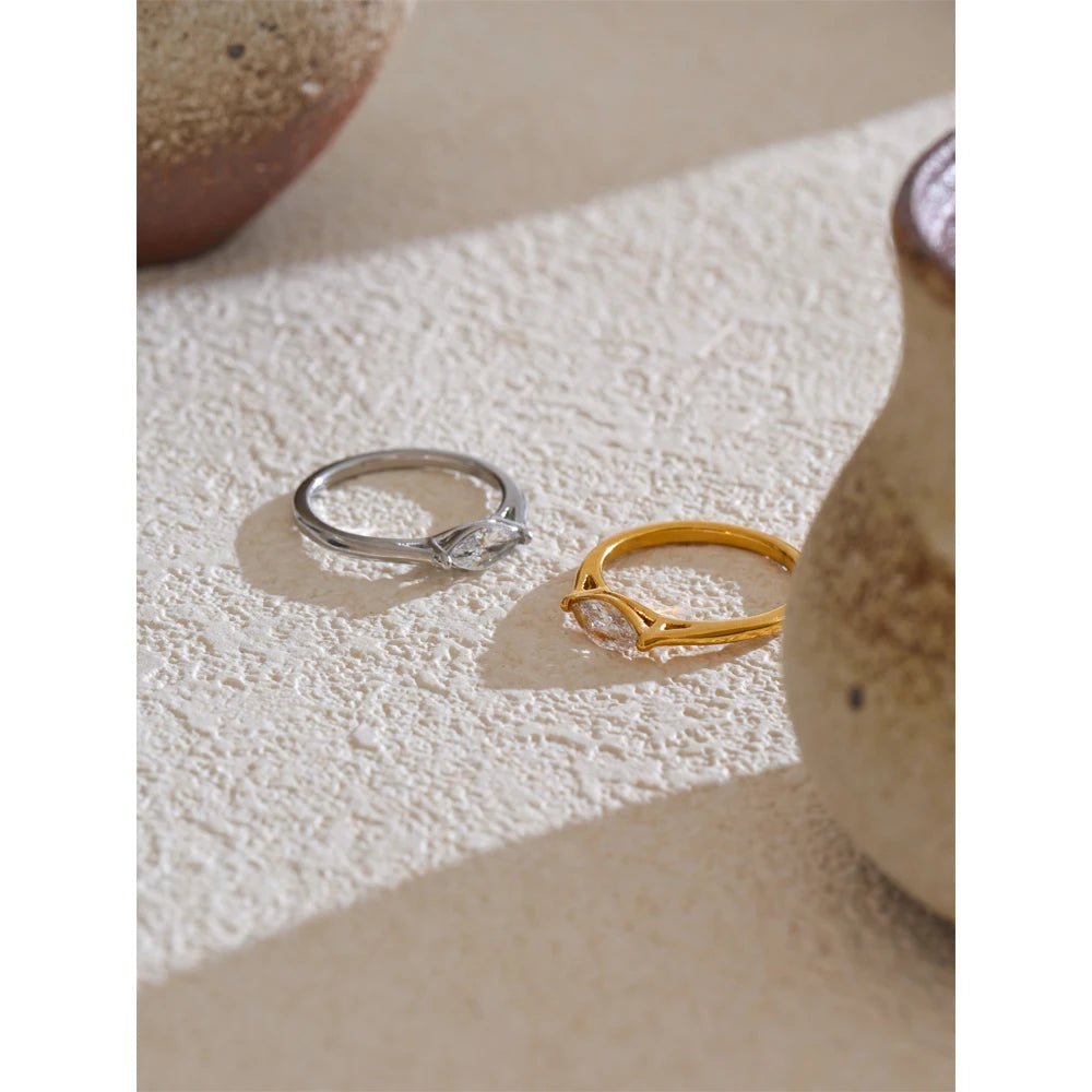 Cubic zirconia geometric ring in 18K gold-plated stainless steel with cubic zirconia.