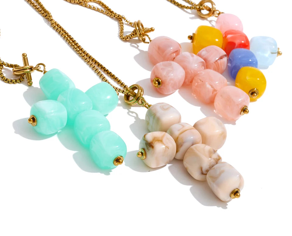 Resin acrylic cross necklace in gold-plated stainless steel with resin and acrylic.