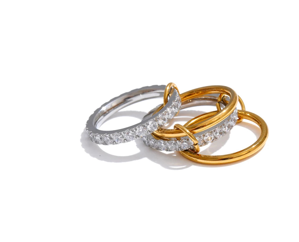 Cubic zirconia geometric layered ring in 18K gold-plated stainless steel with cubic zirconia.