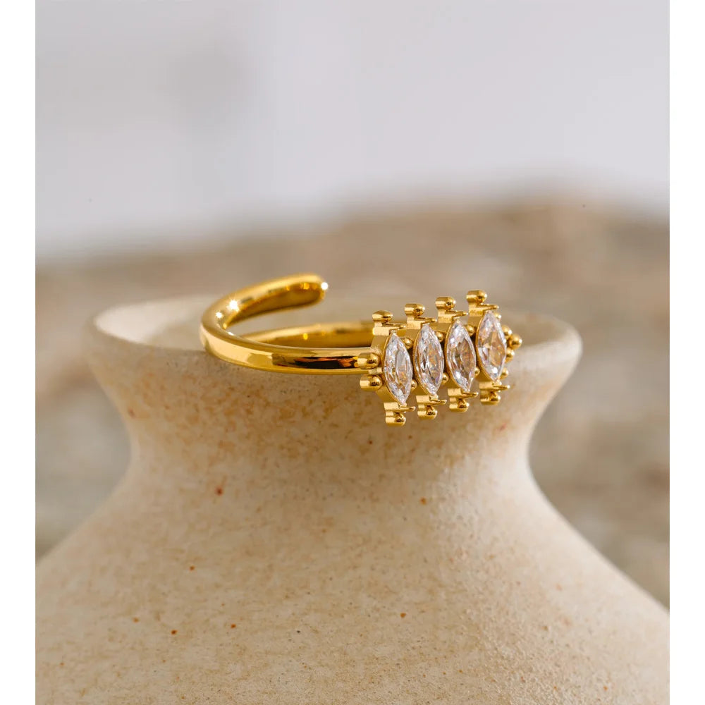 Cubic zirconia geometric ring in 18K gold-plated stainless steel with cubic zirconia.