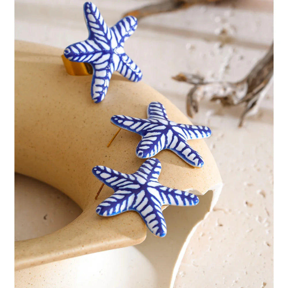 Blue star geometric earrings in gold-plated stainless steel.