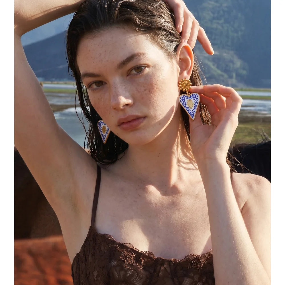 Blue enamel heart earrings in gold-plated stainless steel with enamel.