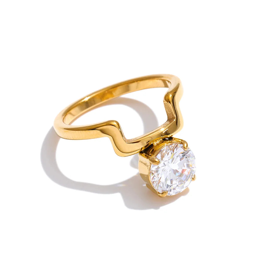 Cubic zirconia geometric ring in 18K gold-plated stainless steel with cubic zirconia.