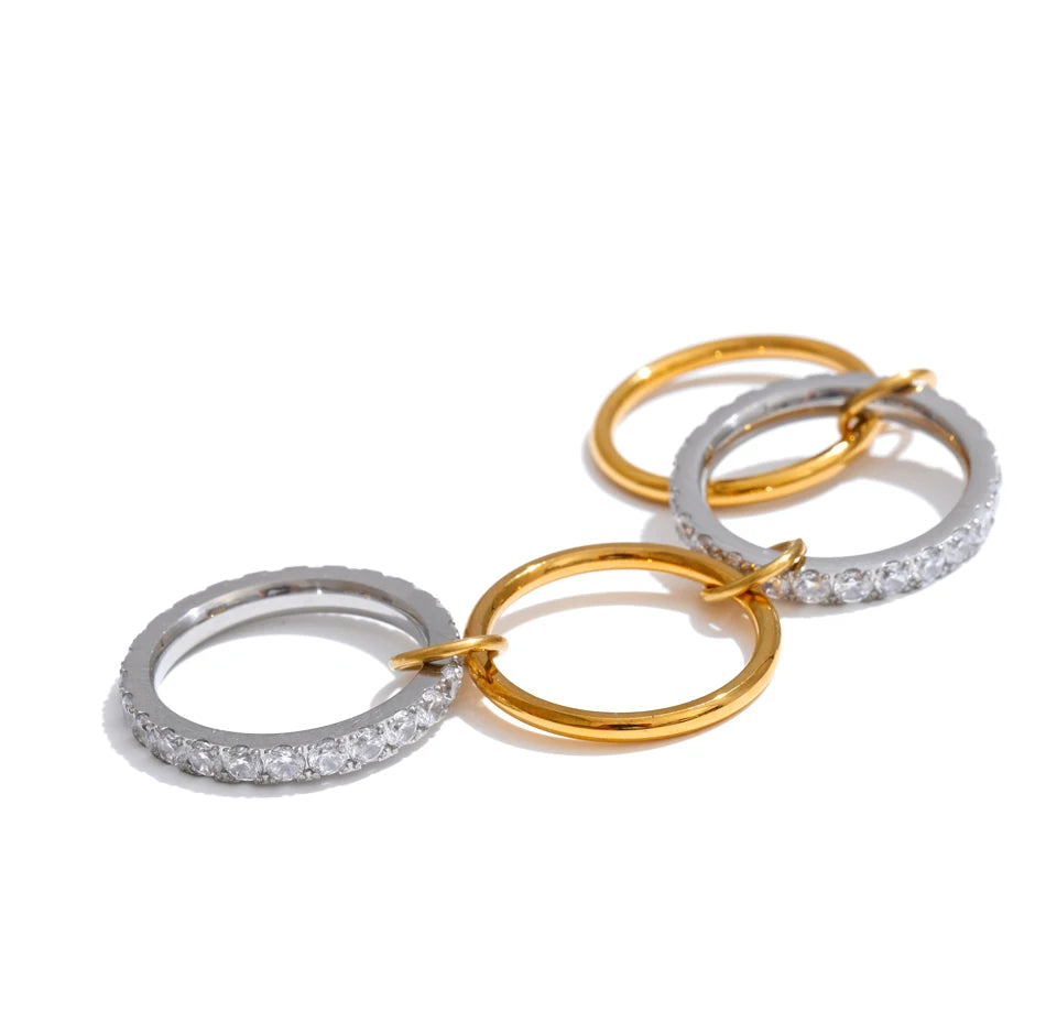 Cubic zirconia geometric layered ring in 18K gold-plated stainless steel with cubic zirconia.
