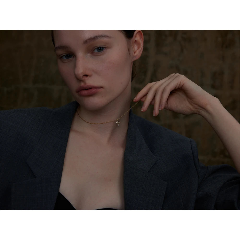 Cubic zirconia cross geometric necklace in gold-plated stainless steel with cubic zirconia.