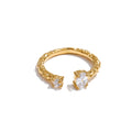 Cubic zirconia geometric ring in 18K gold-plated stainless steel with cubic zirconia.
