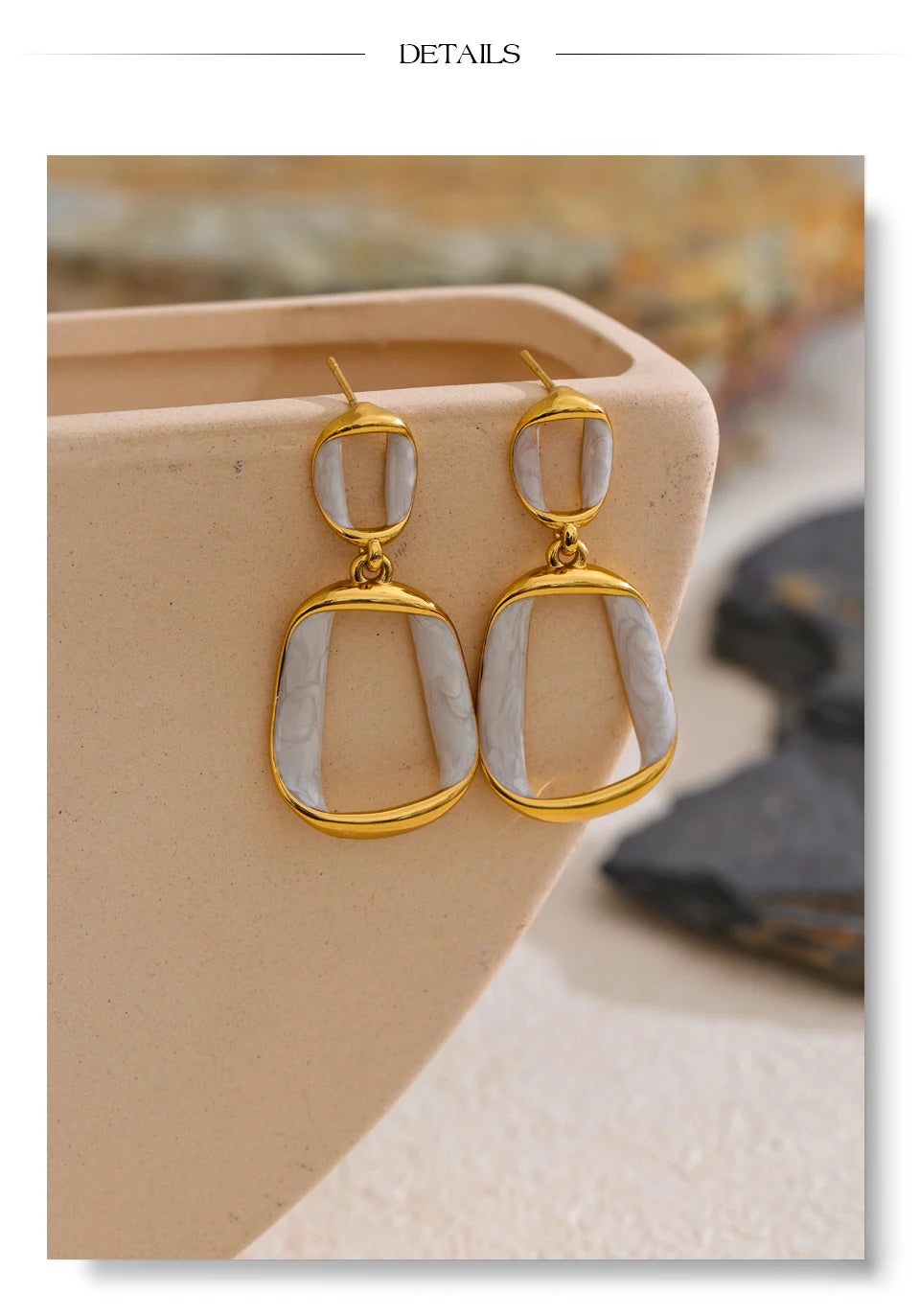 White enamel geometric earrings in gold-plated stainless steel with enamel.