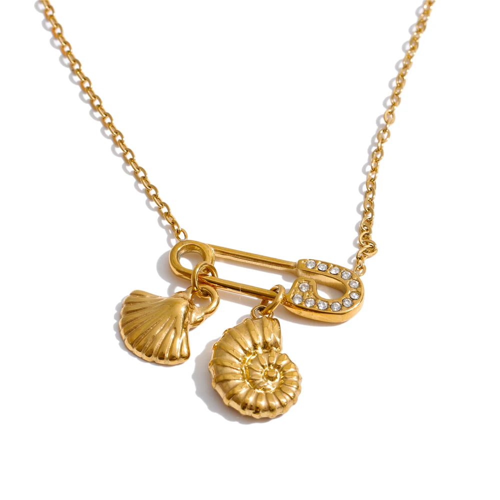 Cubic zirconia shell geometric necklace in gold-plated stainless steel with cubic zirconia and shell.
