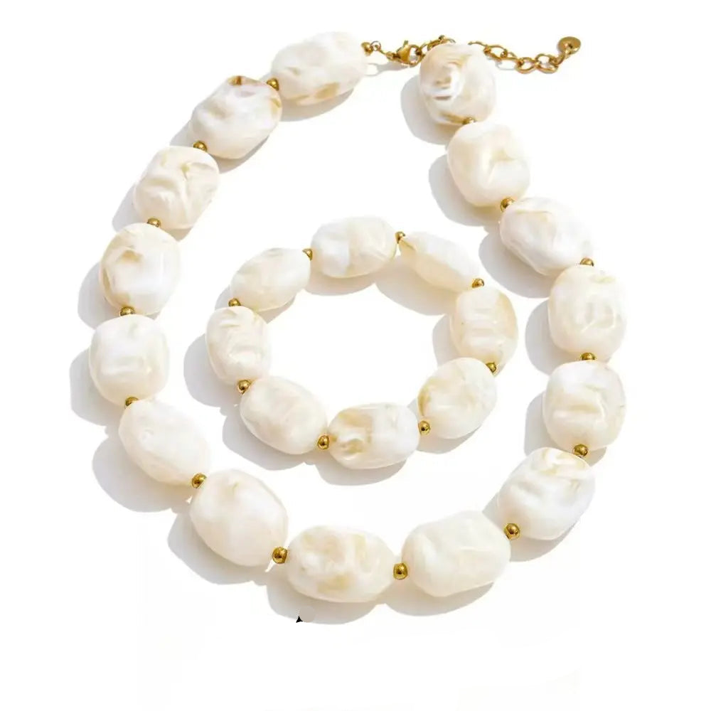 Gold-plated stainless steel necklace with white pearls and acrylic beads.