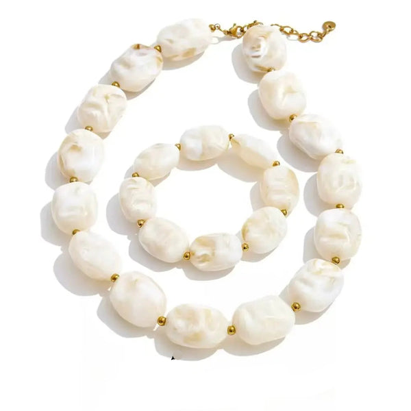 Gold-plated stainless steel necklace with white pearls and acrylic beads.