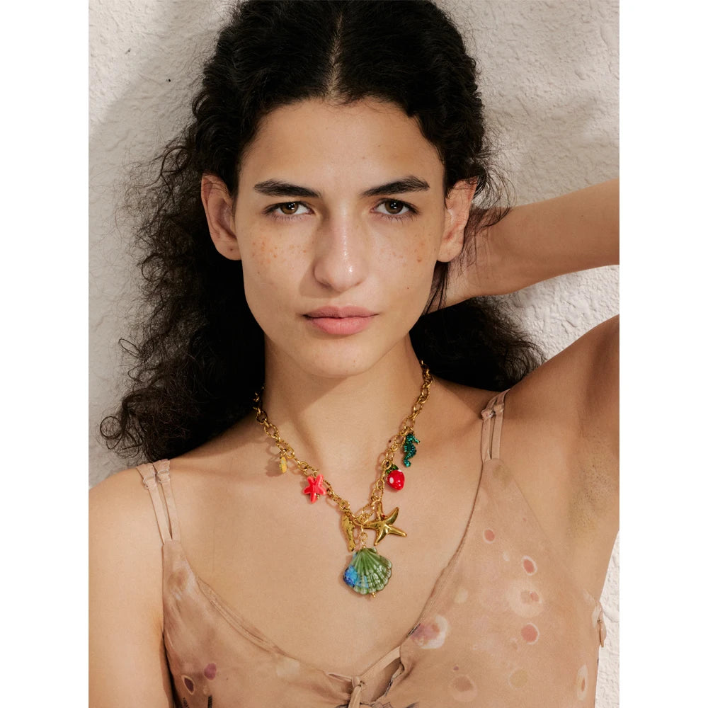Shell enamel star necklace in gold-plated stainless steel with shell and enamel.