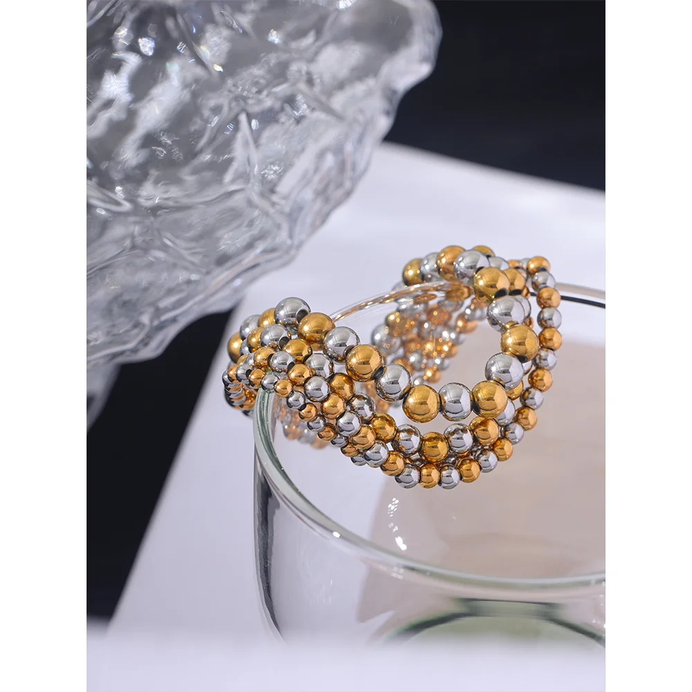 Beaded geometric bracelet in gold-plated stainless steel.