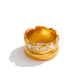 Cubic zirconia geometric ring in 18K gold-plated stainless steel with cubic zirconia.