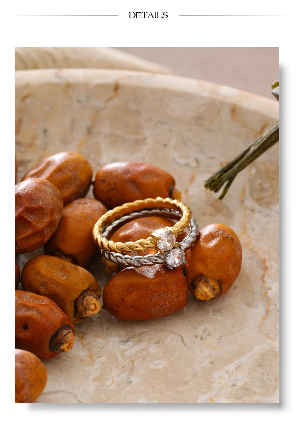 Cubic zirconia geometric ring in 18K gold-plated stainless steel with cubic zirconia.