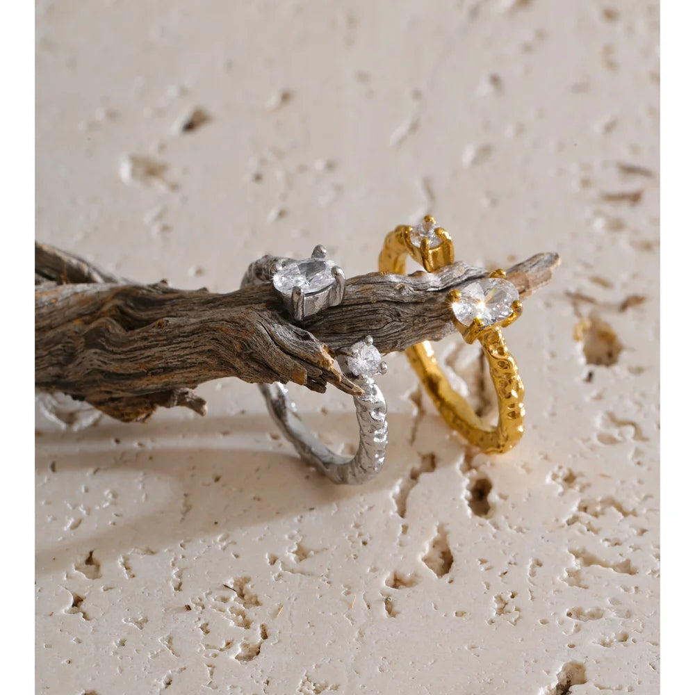 Cubic zirconia geometric ring in 18K gold-plated stainless steel with cubic zirconia.