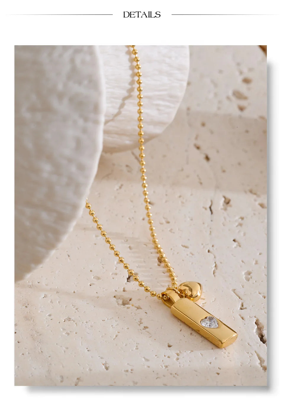 Cubic zirconia heart geometric necklace in gold-plated stainless steel with cubic zirconia.