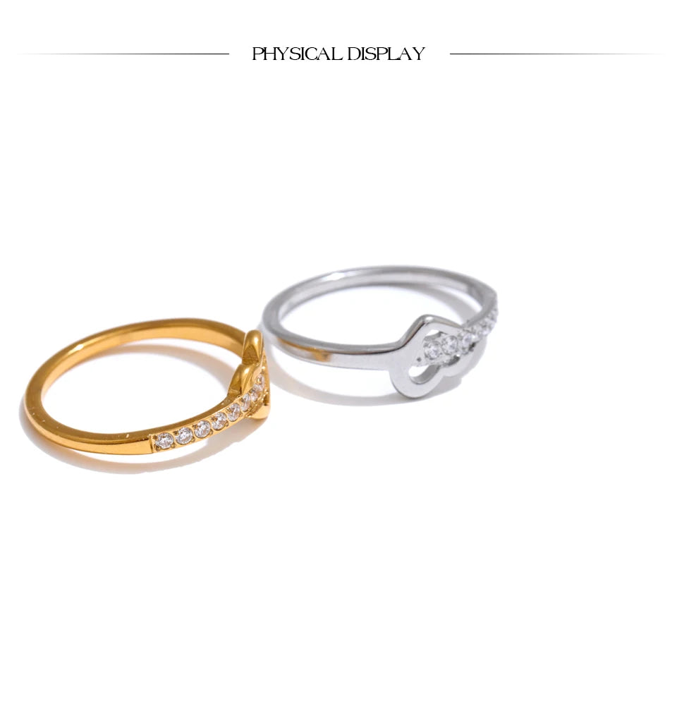 Cubic zirconia heart cross ring in 18K gold-plated stainless steel with cubic zirconia.