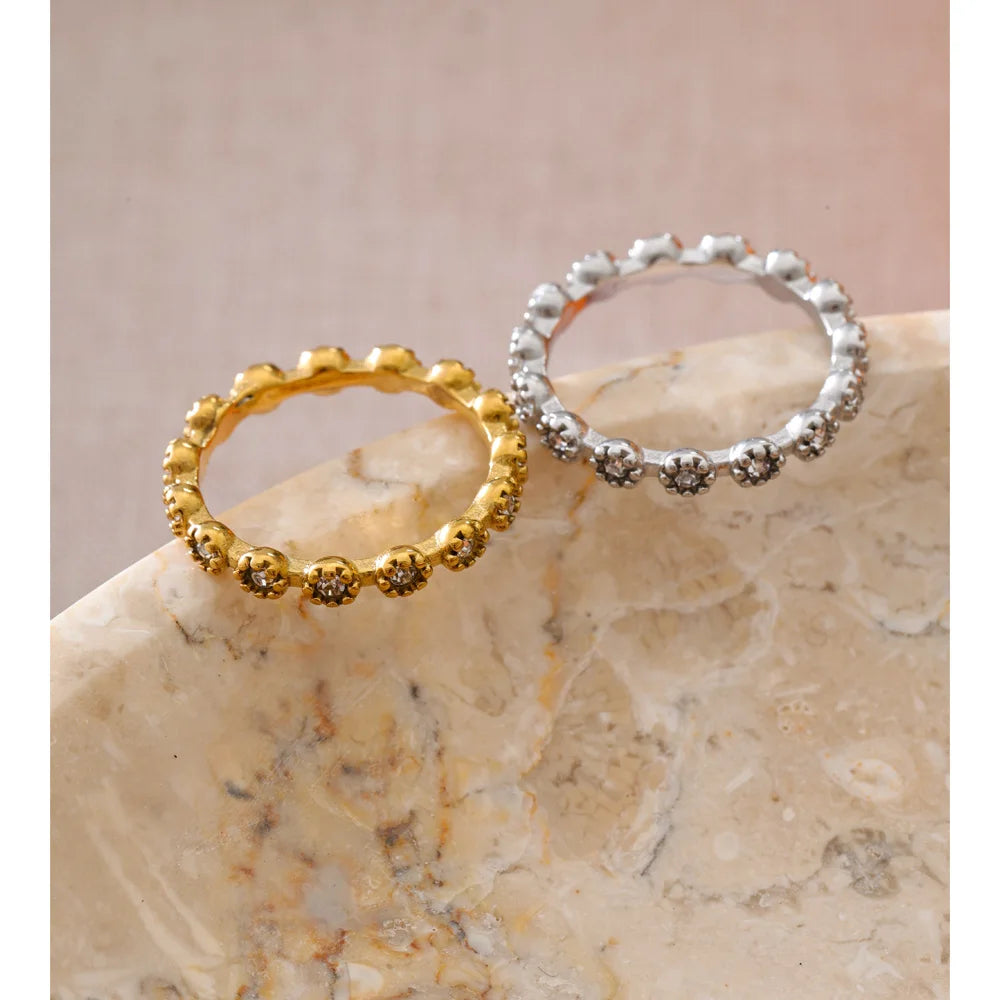 Cubic zirconia flower geometric ring in 18K gold-plated stainless steel with cubic zirconia.