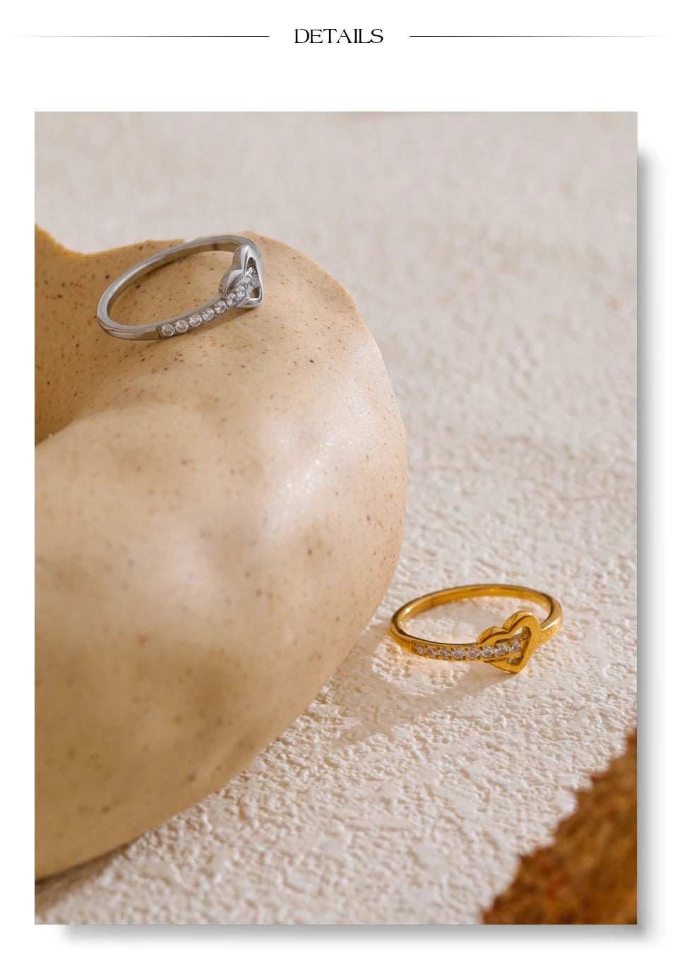 Cubic zirconia heart cross ring in 18K gold-plated stainless steel with cubic zirconia.