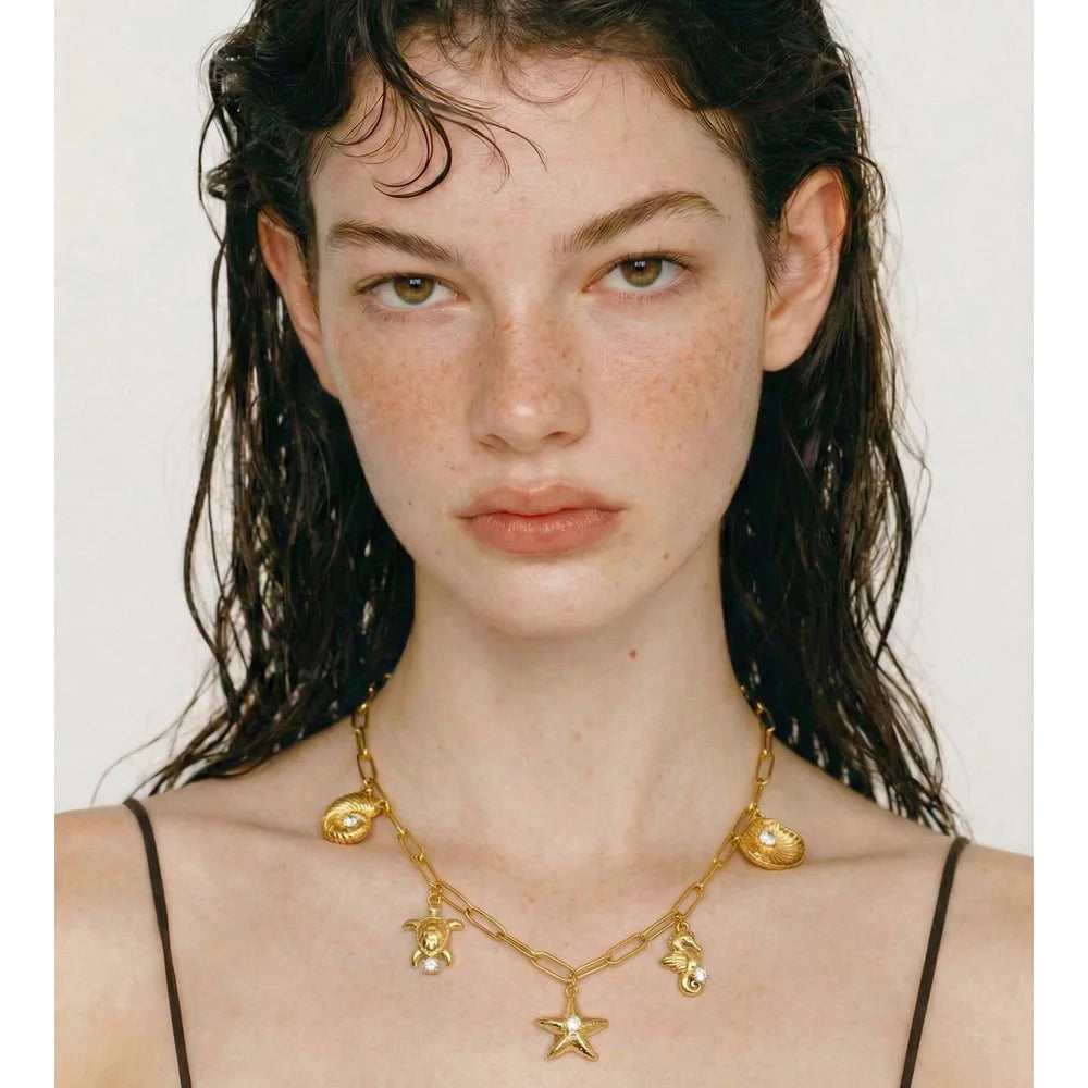 Cubic zirconia shell star necklace in gold-plated stainless steel with cubic zirconia and shell.
