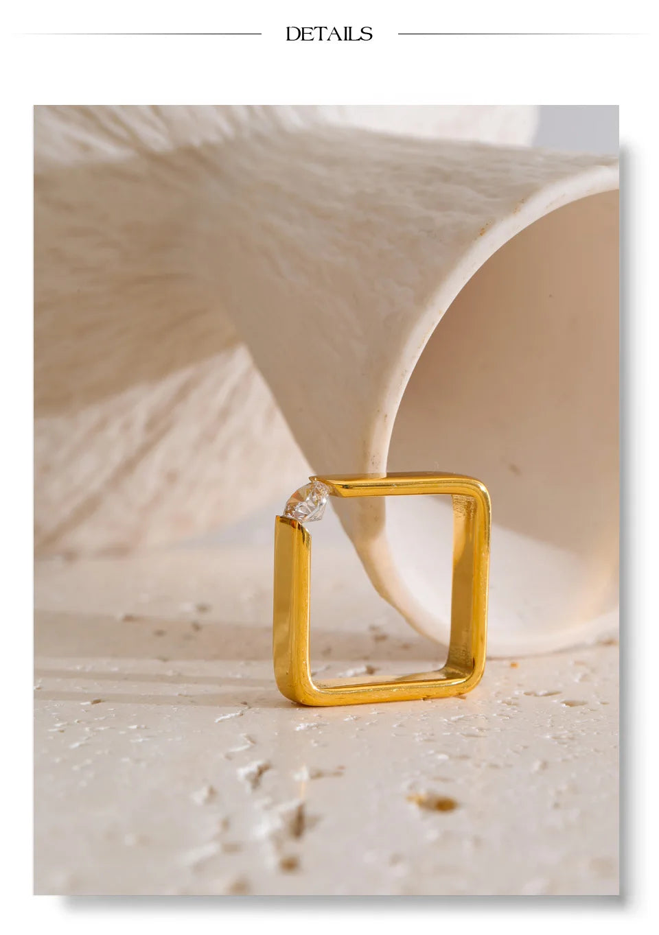 Cubic zirconia minimalist geometric ring in 18K gold-plated stainless steel with cubic zirconia.