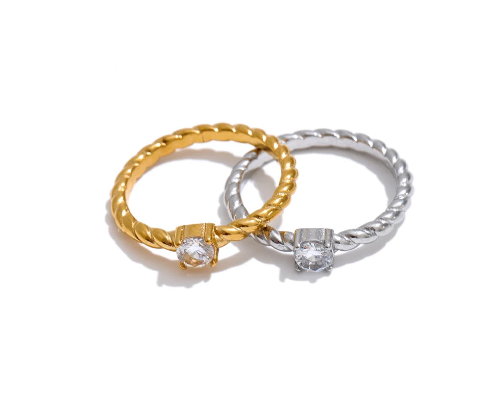 Cubic zirconia geometric ring in 18K gold-plated stainless steel with cubic zirconia.