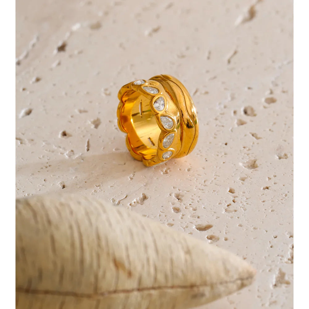 Cubic zirconia geometric ring in 18K gold-plated stainless steel with cubic zirconia.