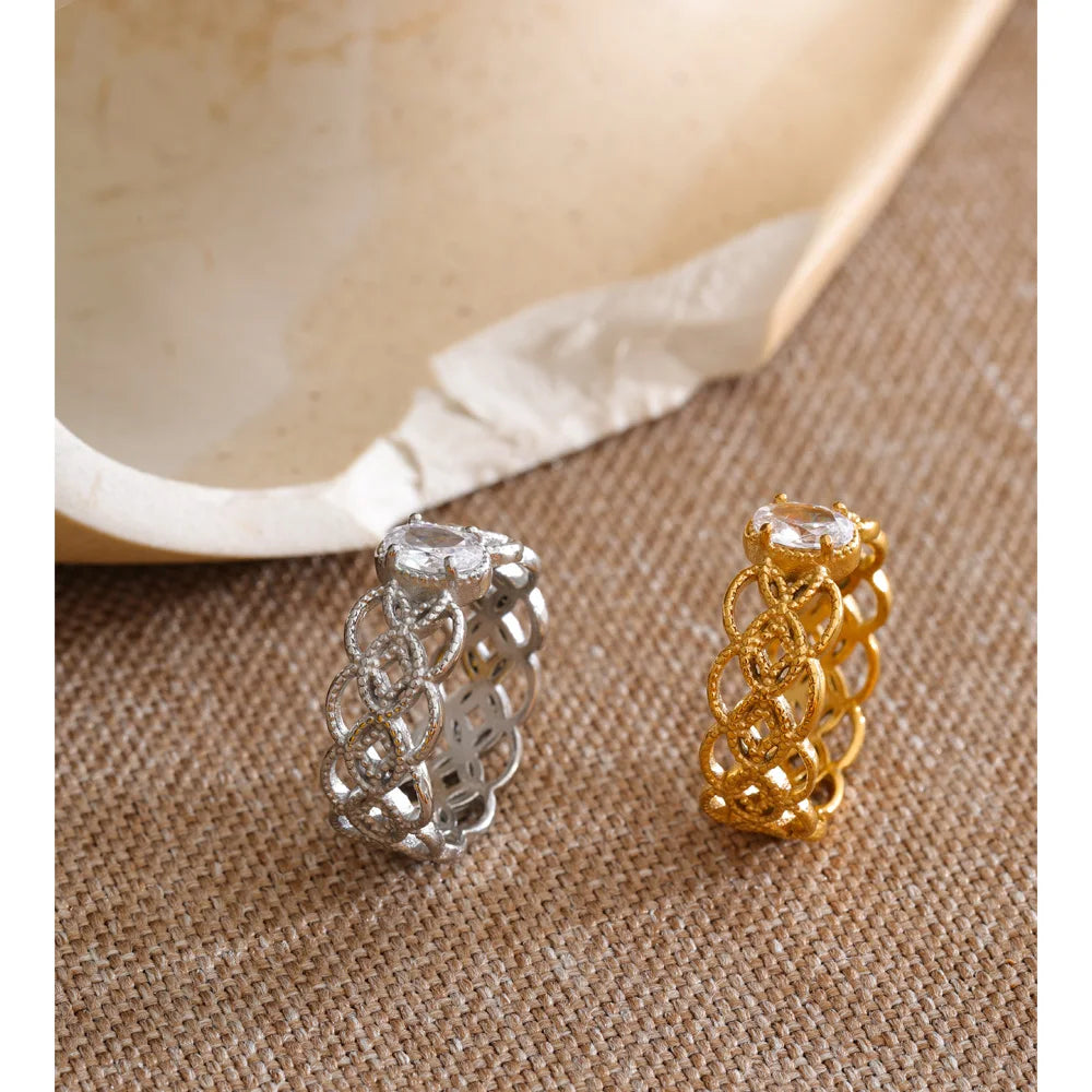 Cubic zirconia geometric ring in 18K gold-plated stainless steel with cubic zirconia.