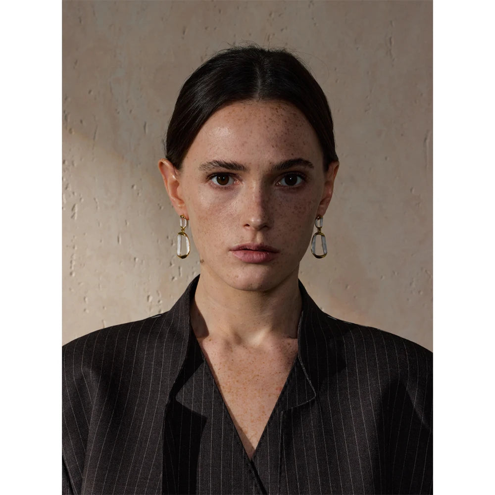 White enamel geometric earrings in gold-plated stainless steel with enamel.