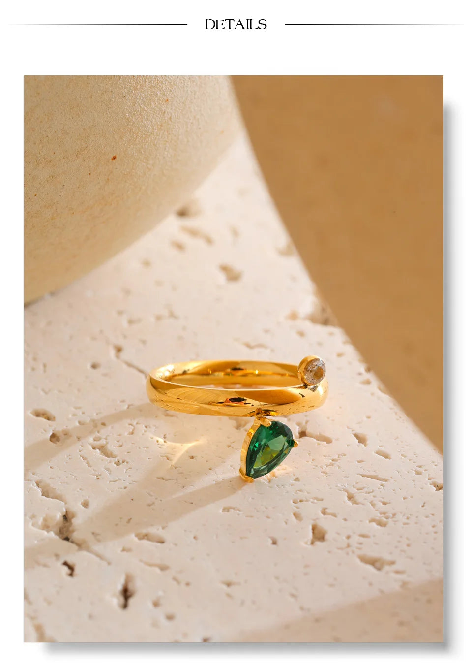 Green cubic zirconia geometric ring in 18K gold-plated stainless steel with cubic zirconia.