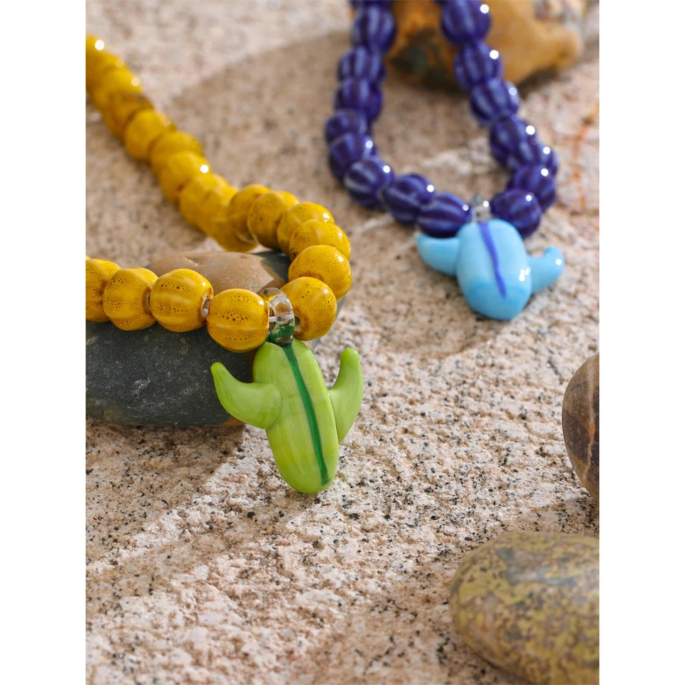 Blue beaded geometric necklace in gold-plated stainless steel.