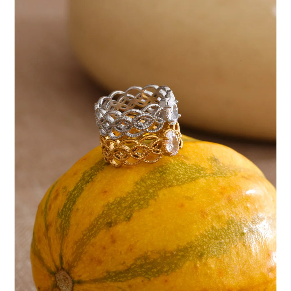 Cubic zirconia geometric ring in 18K gold-plated stainless steel with cubic zirconia.
