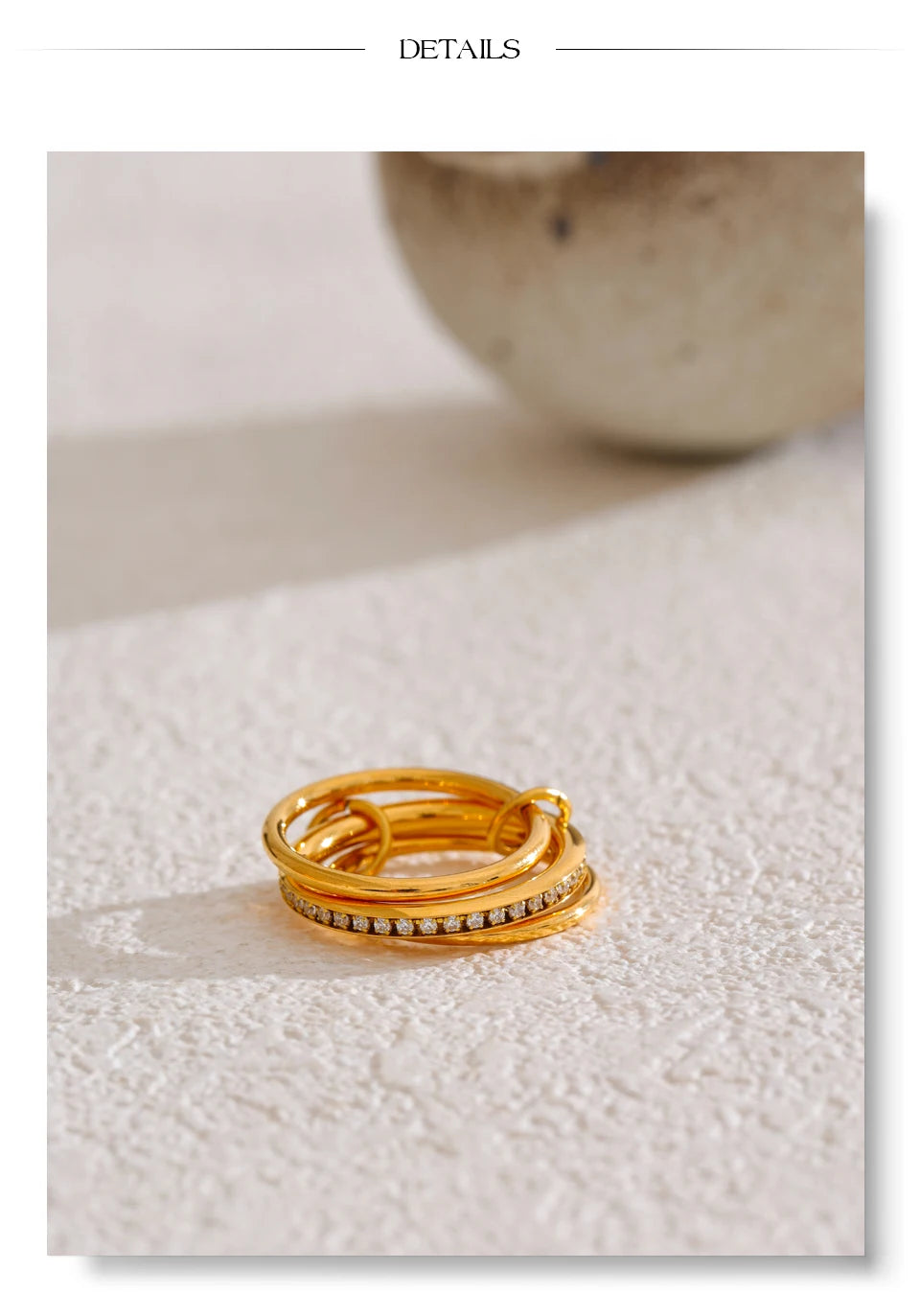Cubic zirconia geometric layered ring in 18K gold-plated stainless steel with cubic zirconia.