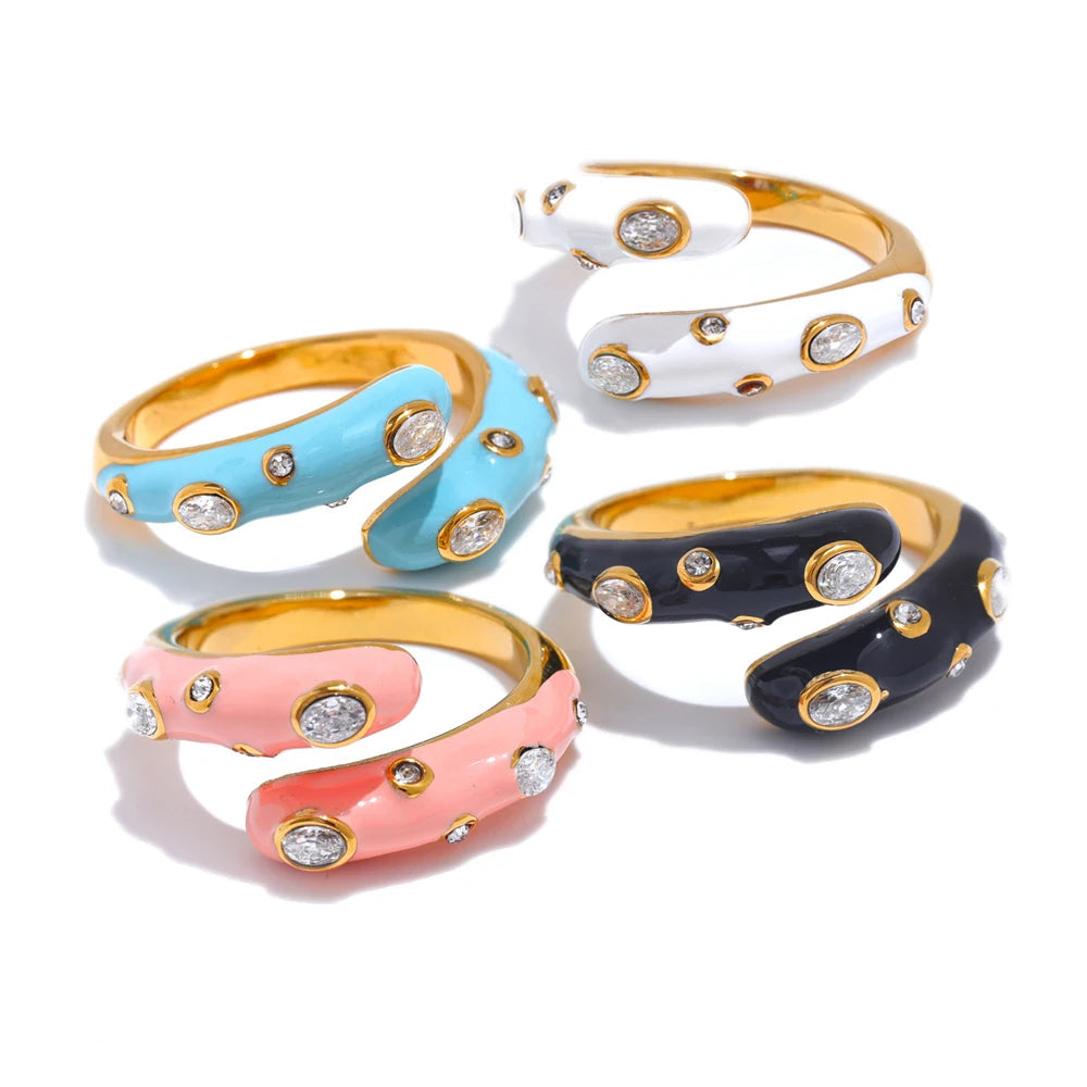 Ring set with gold-plated stainless steel bands and cubic zirconia stones in pink, blue, and white enamel finishes.
