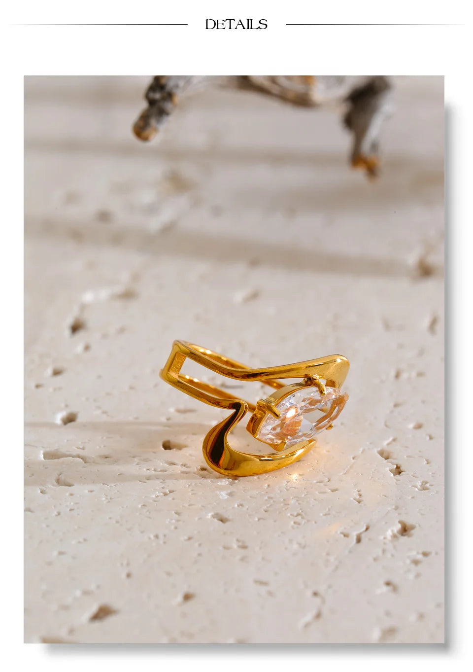 Cubic zirconia geometric ring in 18K gold-plated stainless steel with cubic zirconia.