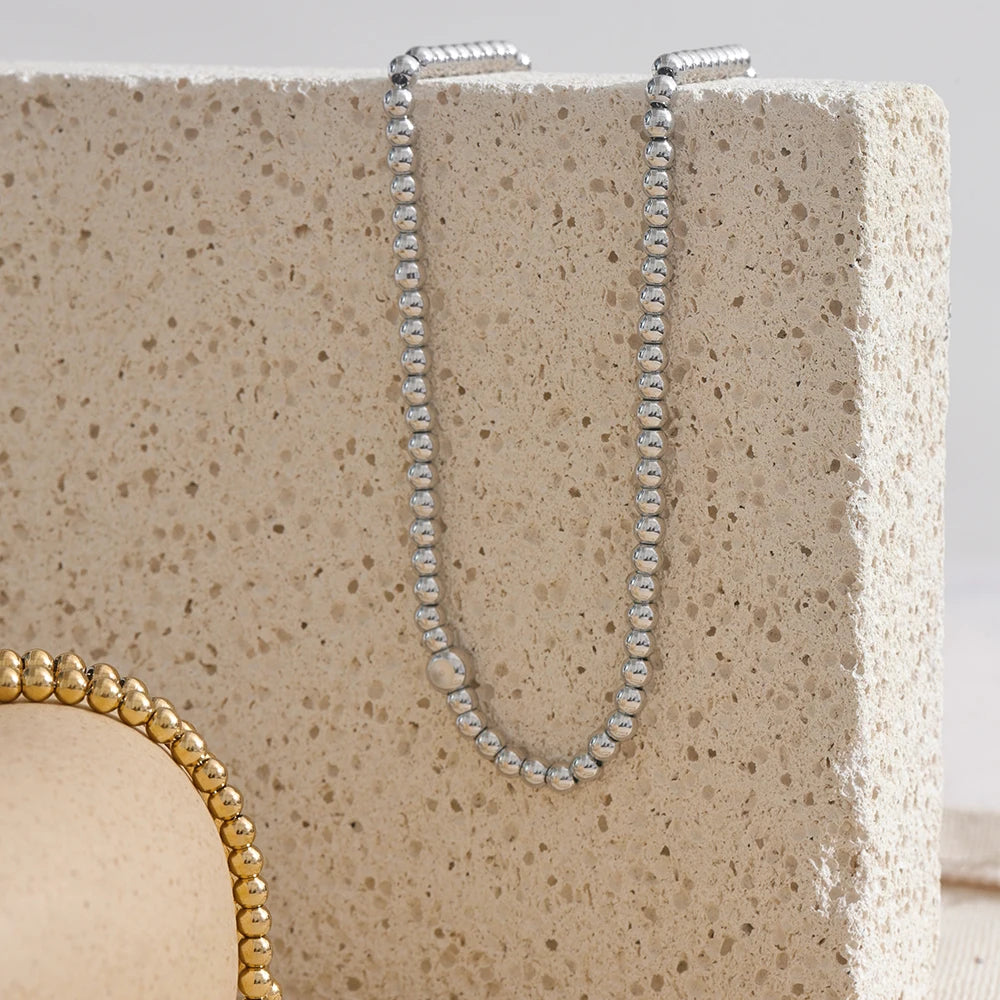 Cubic zirconia beaded geometric necklace in 18K gold-plated stainless steel with cubic zirconia.