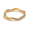 Cubic zirconia geometric ring in 18K gold-plated stainless steel with cubic zirconia.