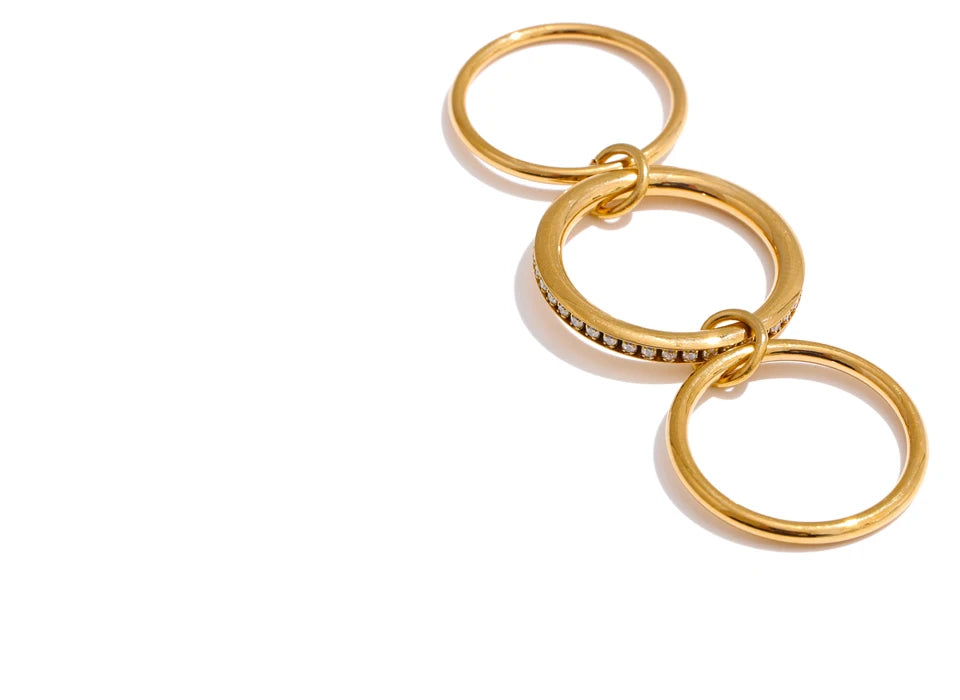 Cubic zirconia geometric layered ring in 18K gold-plated stainless steel with cubic zirconia.