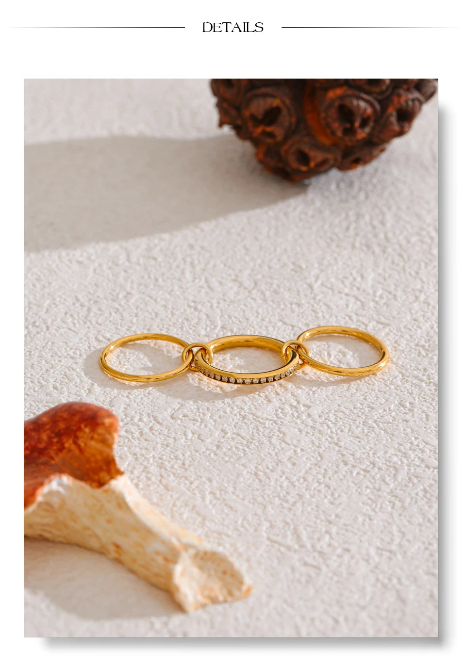 Cubic zirconia geometric layered ring in 18K gold-plated stainless steel with cubic zirconia.