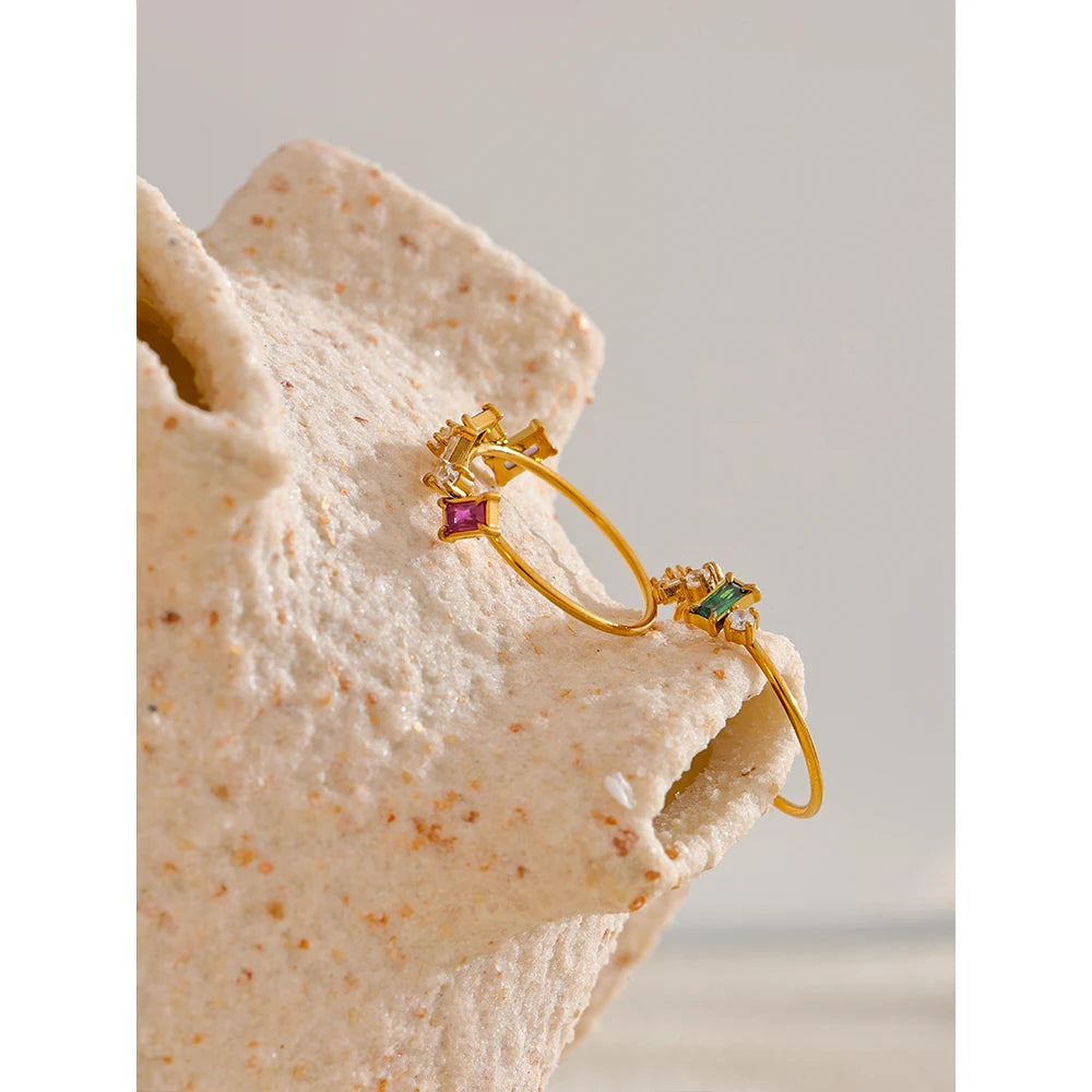 Cubic zirconia multi-color geometric ring in 18K gold-plated stainless steel with cubic zirconia.
