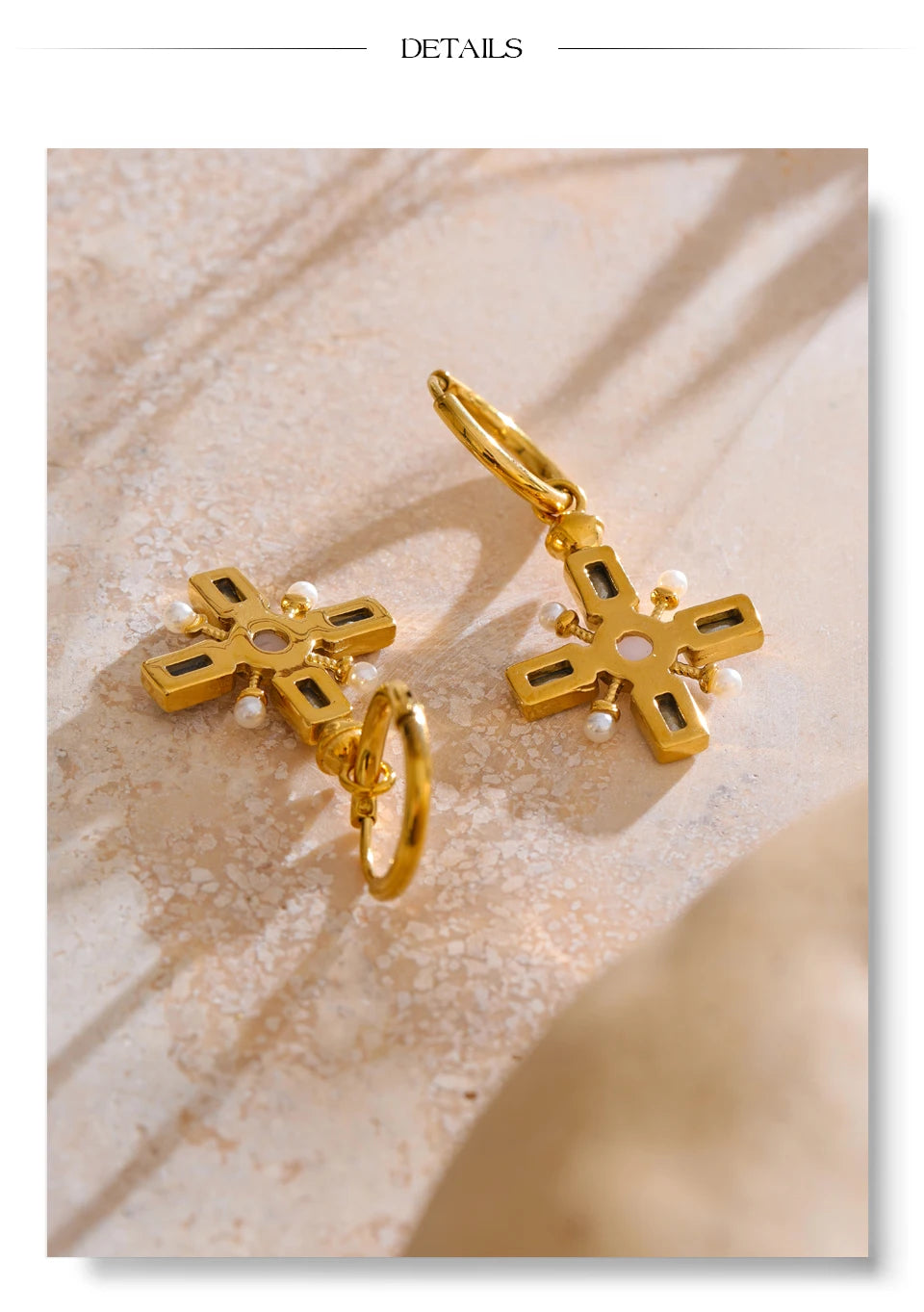 Cubic zirconia pearl cross earrings in gold-plated stainless steel with pearl and cubic zirconia.