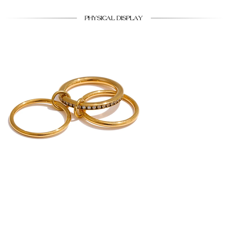 Cubic zirconia geometric layered ring in 18K gold-plated stainless steel with cubic zirconia.
